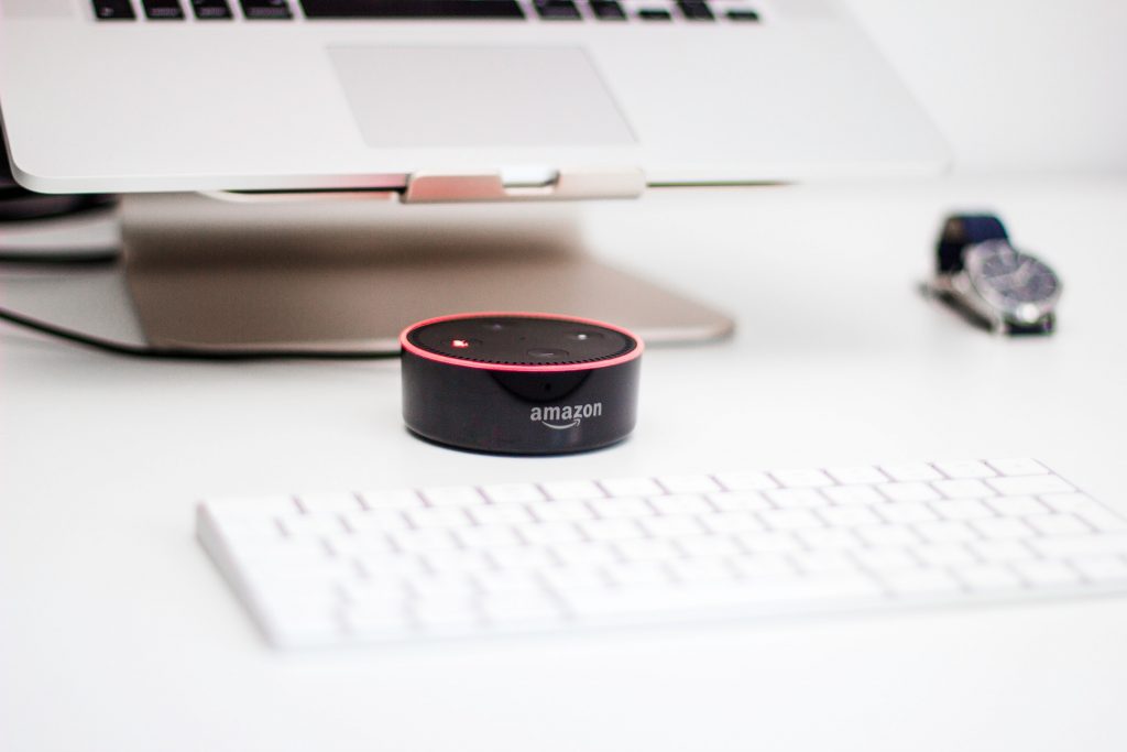 amazon echo dot sitting on a keyboard